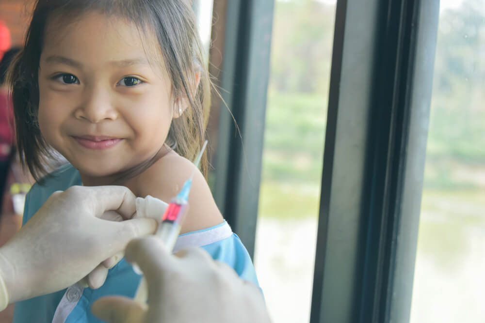 Doctor in Medical Gloves Vaccinating Cute Little Girl