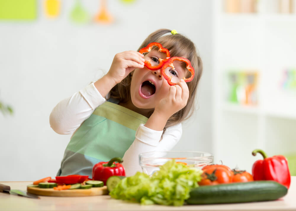 Kid Girl Having Fun With Food Vegetables at Kitchen