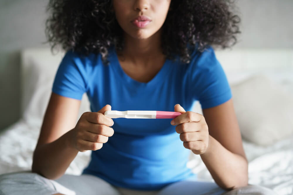 A girl getting results from pregnancy test kit