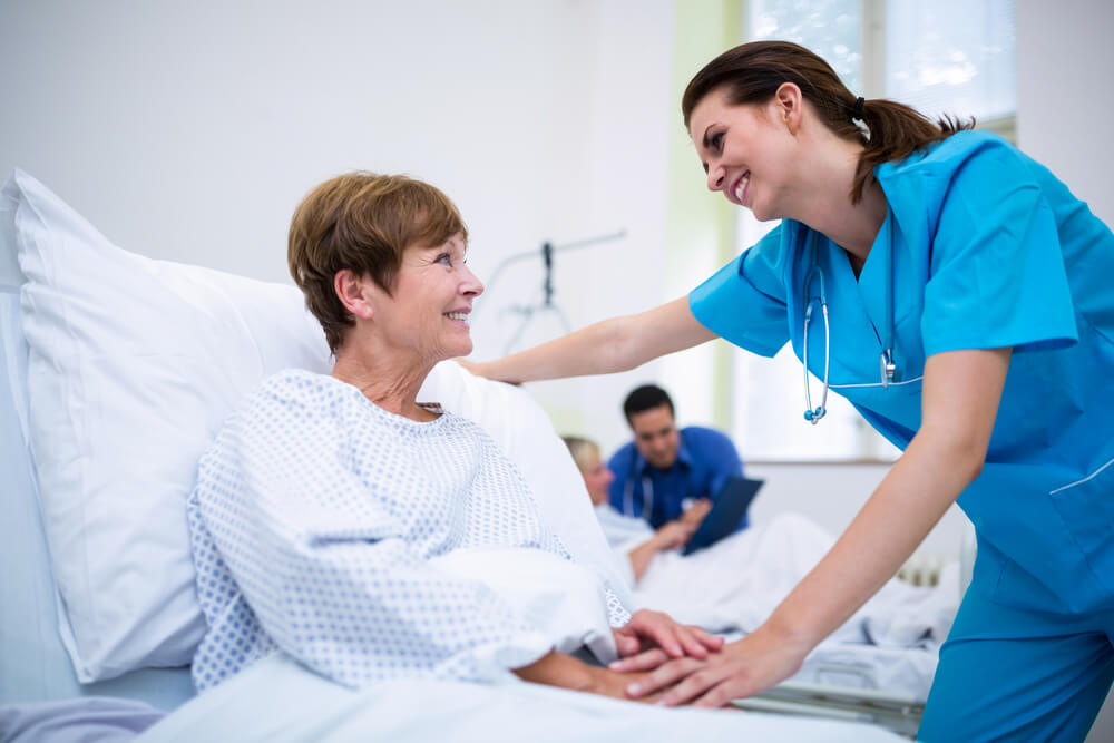 Nurse Consoling a Patient in Ward at Hospital