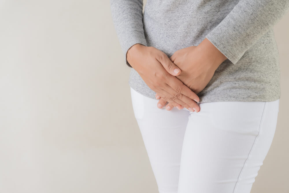 Young Woman With Hands Pressing Her Lower Abdomen, Gynecological Problems