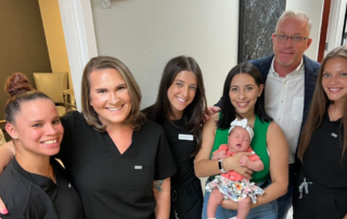 Medical staff with patient and newborn grouped together for picture