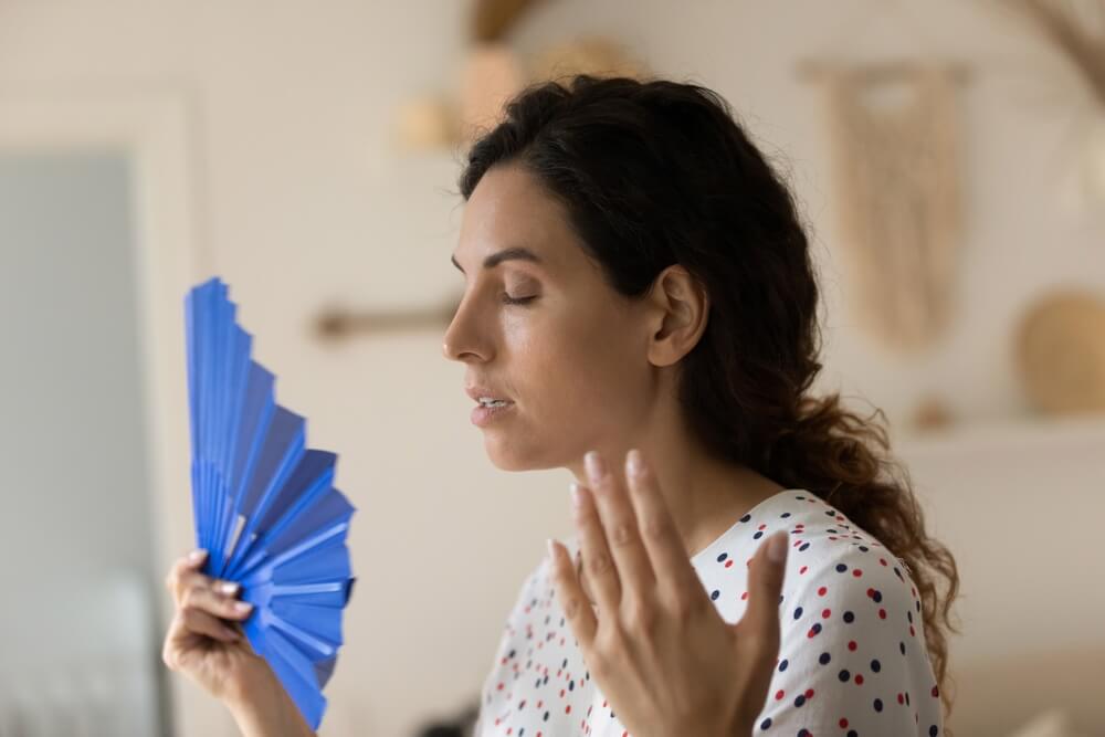 Exhausted Overheated Sweaty Woman Suffering From Heat at Home Without Conditioner