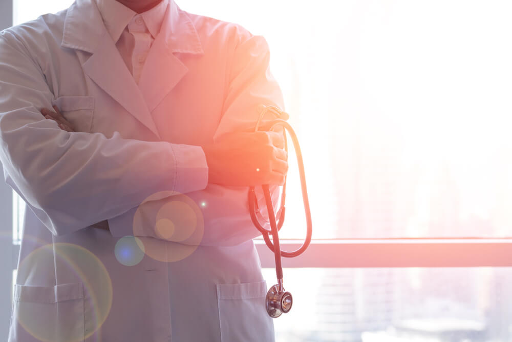 Doctor in White Uniform Holding Stethoscope in Hospital