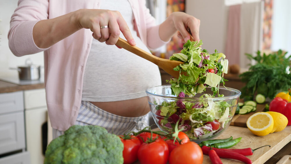  Pregnant Woman Preparing Meal on Kitchen, Making Salad.