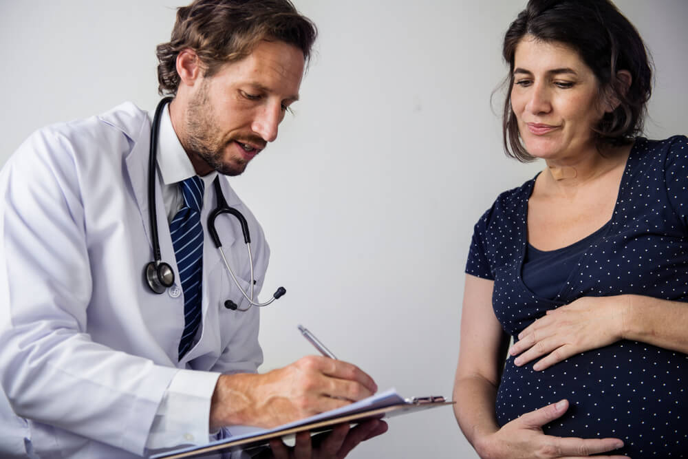 Pregnant Woman Having Fetal Monitoring by Doctor